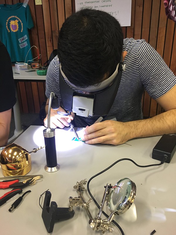 Attendee at the 2017 GOSH Gathering soldering a printed circuit board